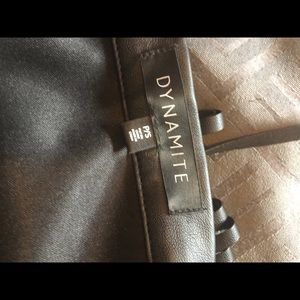 XS black leather like skirt with frills .